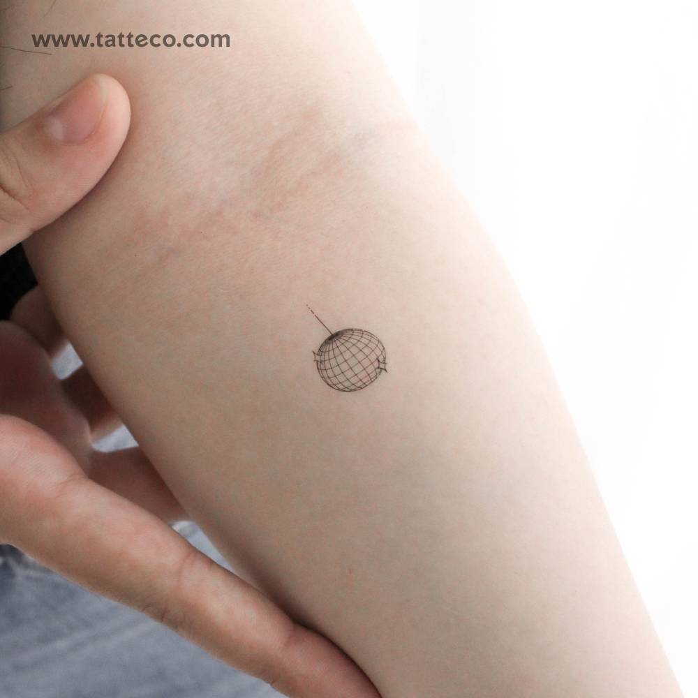Little disco ball temporary tattoo located on the inner forearm.