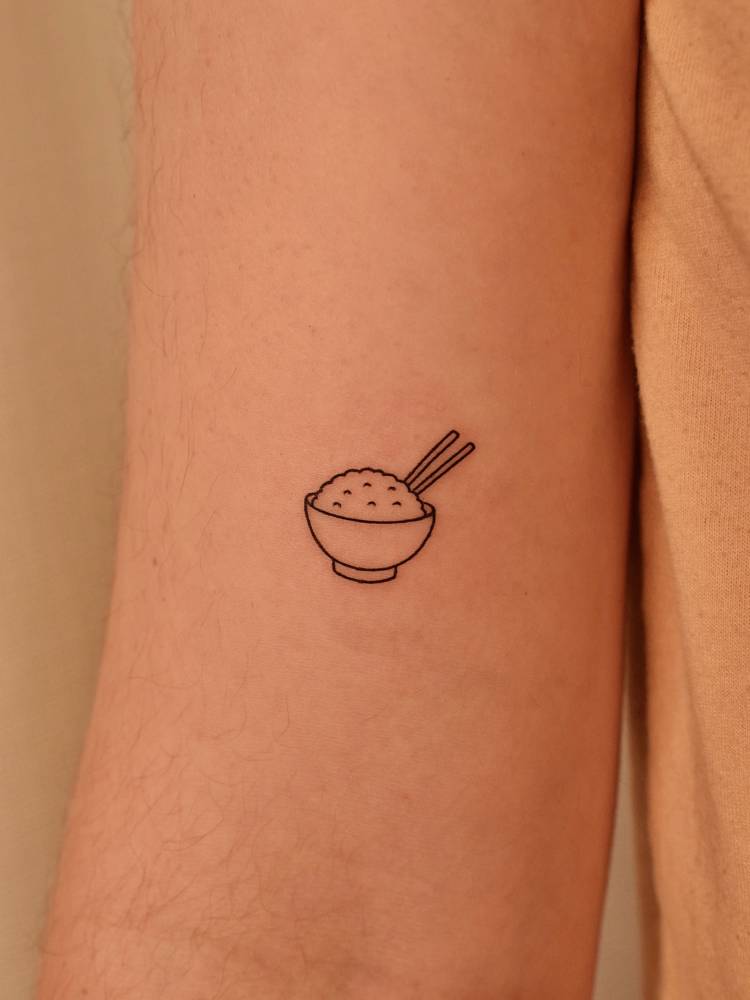 Rice bowl tattoo in minimalistic style done on the bicep.
