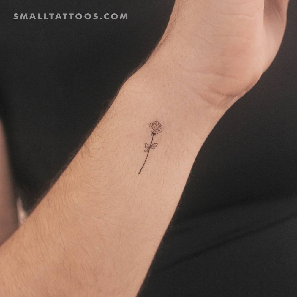 Small fine line rose outline temporary tattoo located on the wrist.