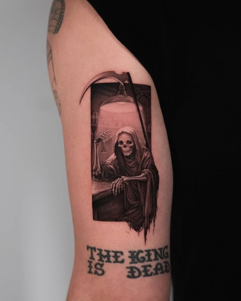 Micro-realistic Grim Reaper tattoo located on the tricep.