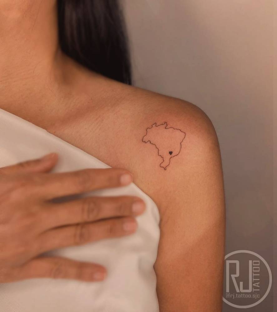 Brazil map tattoo in fine line style located on the shoulder.