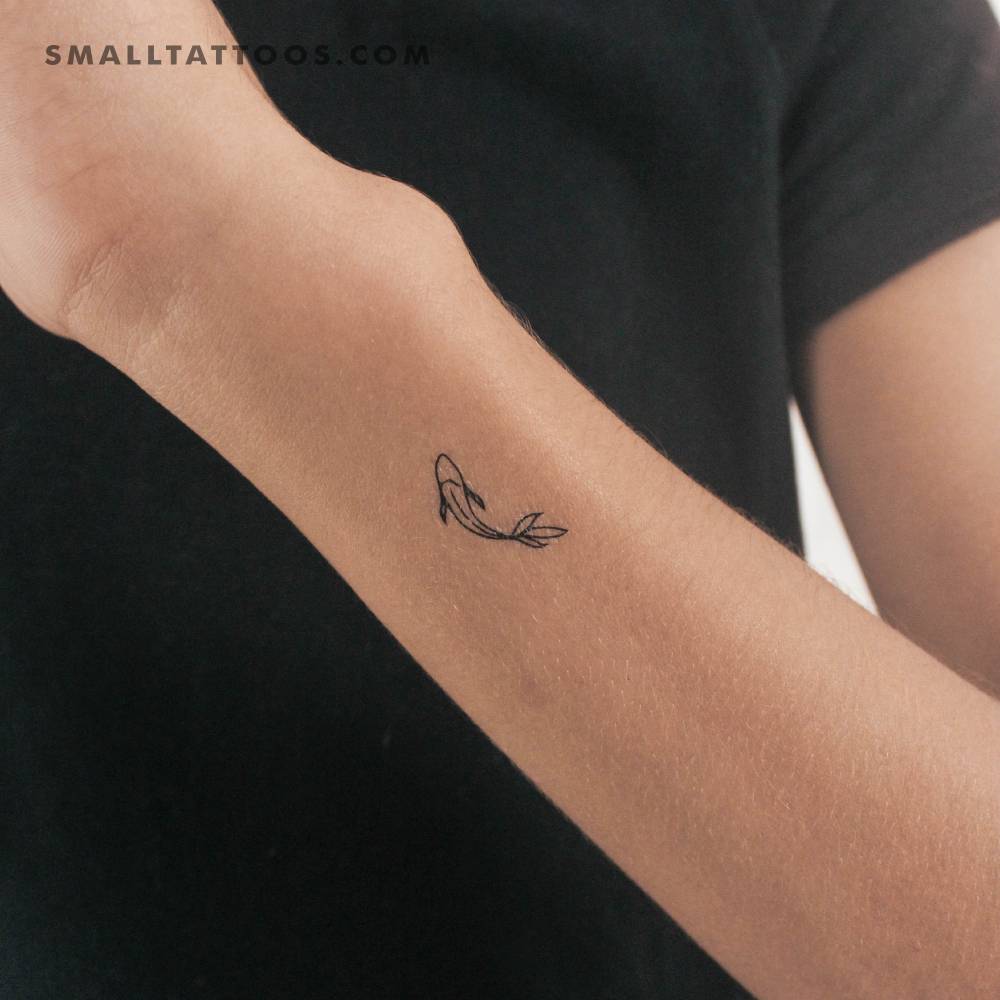 Minimalist koi fish temporary tattoo located on the wrist.