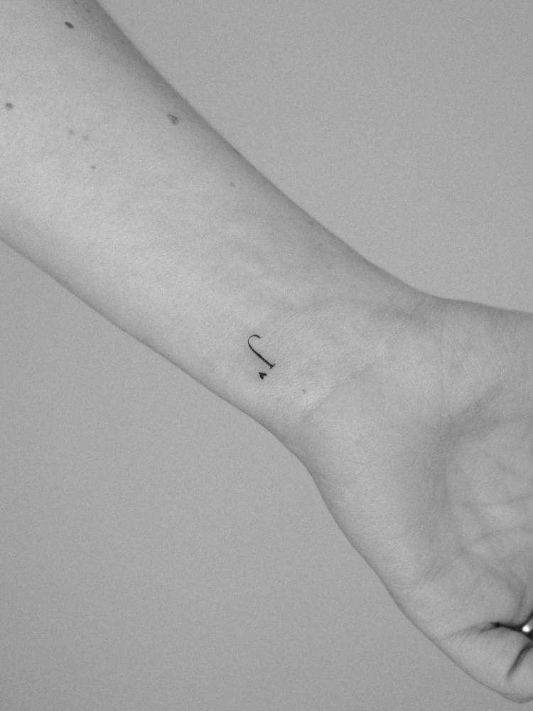 Letter "J" and micro heart tattoo located on the wrist.