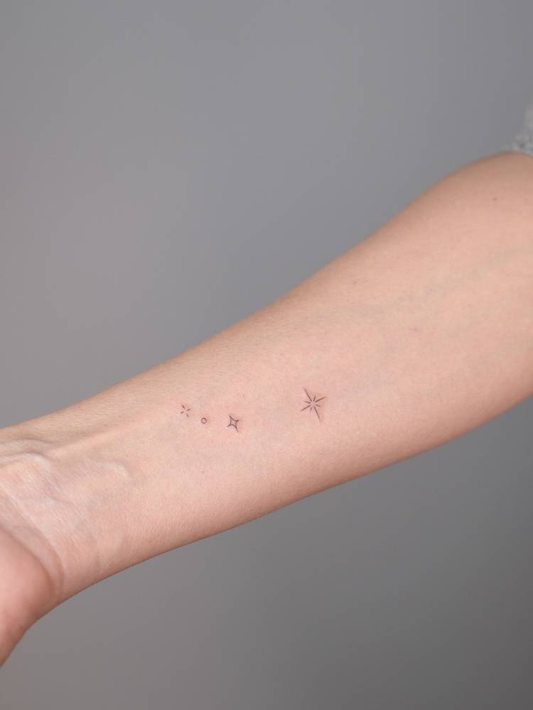 Aries constellation tattoo located on the wrist, minimalistic style.