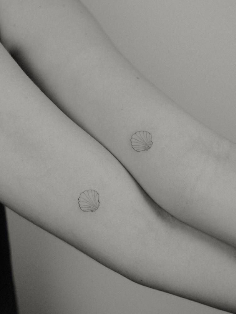 Matching fine line scallop shell tattoo for best friends.