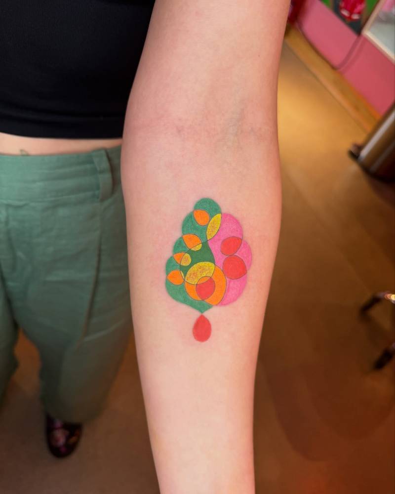 Abstract style design tattooed on the inner forearm.