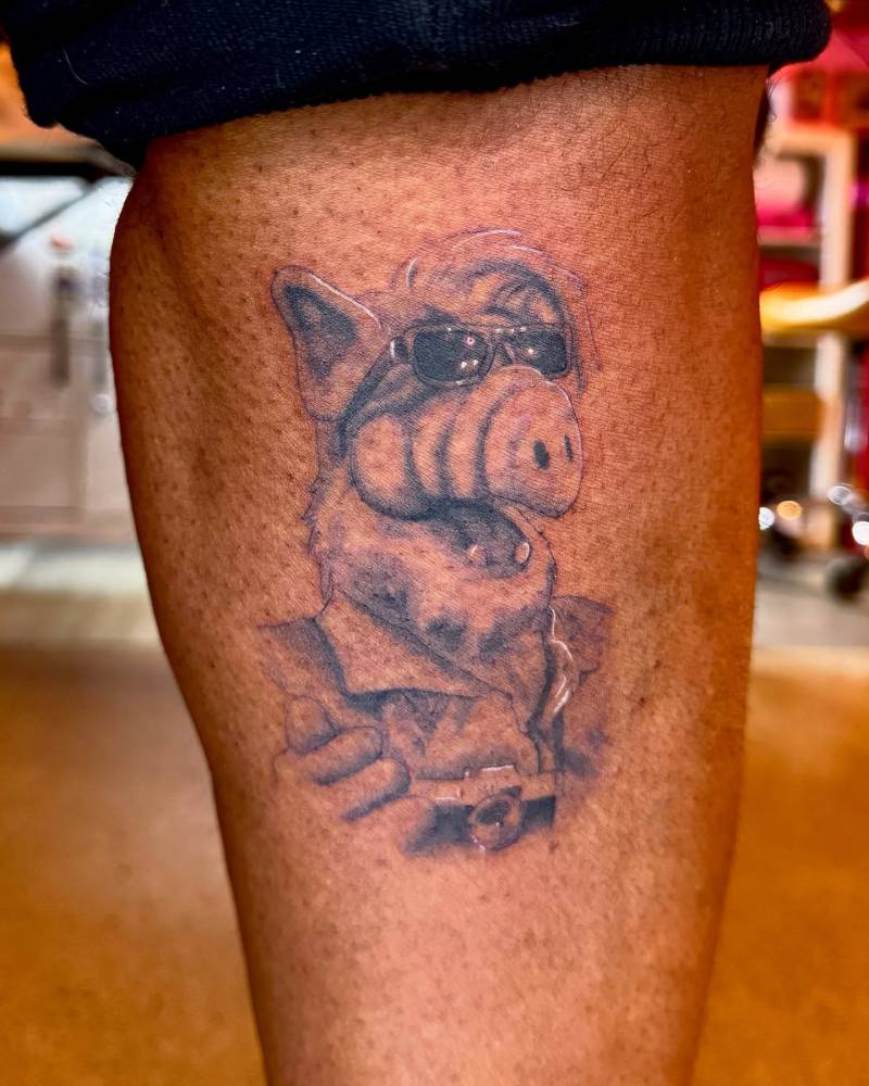 ALF portrait tattoo located on the shin.