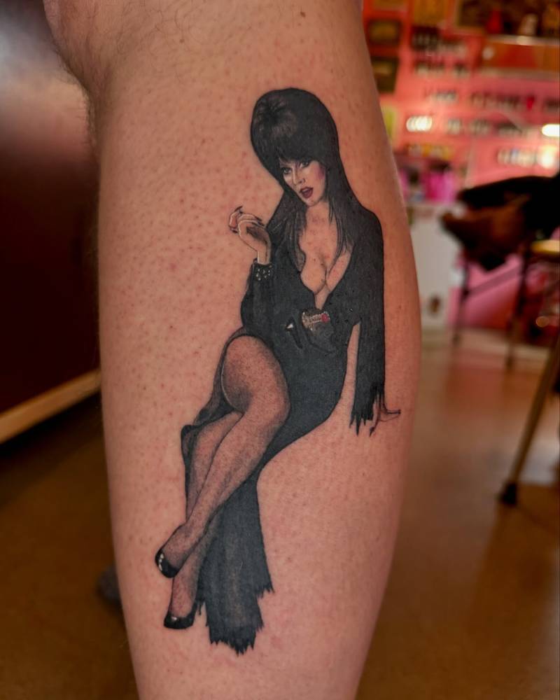 Elvira tattoo in realistic style located on the calf.