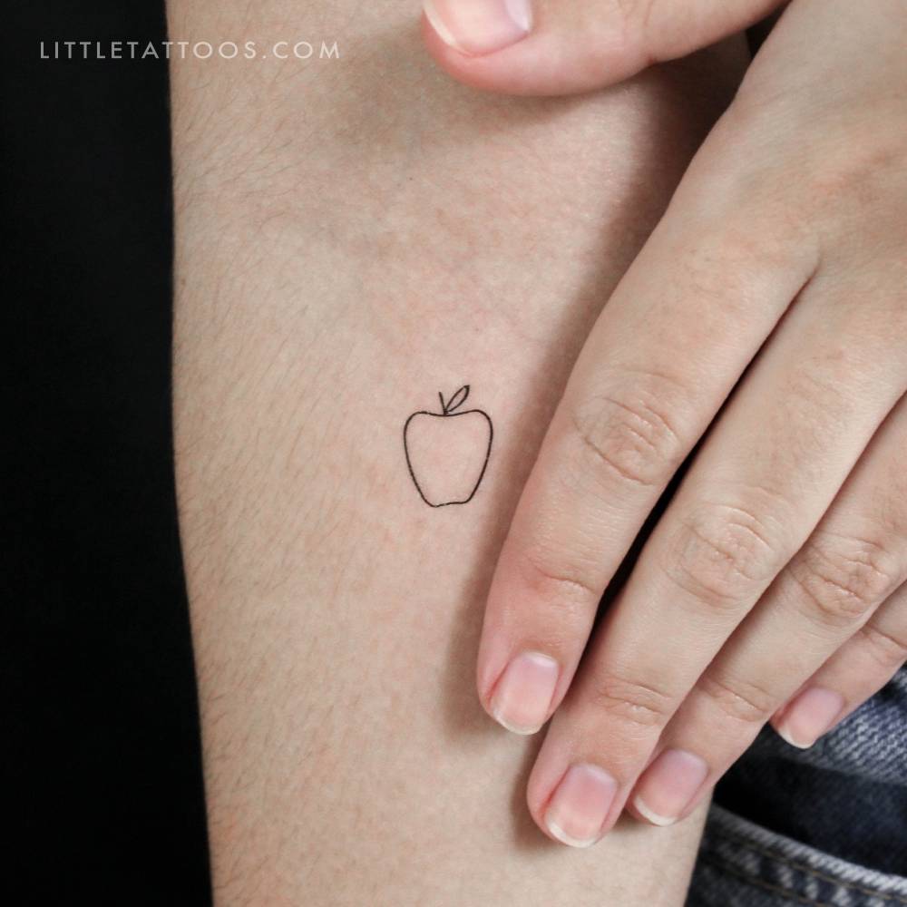 Minimalist little apple temporary tattoo located on the inner forearm.