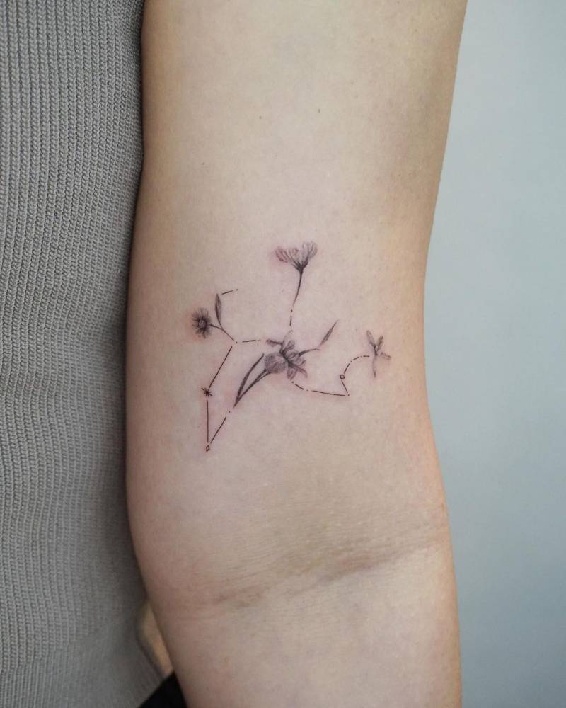 Floral Leo constellation tattoo located on the bicep.