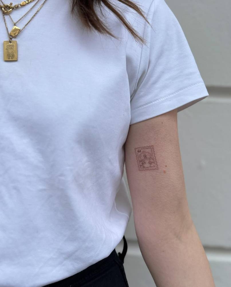 Orchid stamp tattoo done on the inner arm.