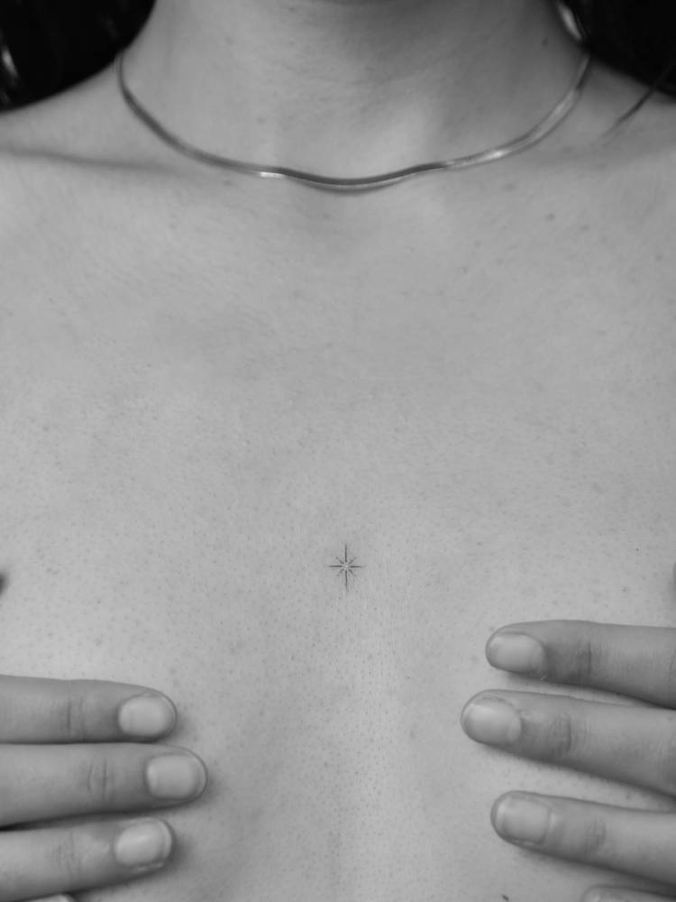 North star tattoo in minimalistic style done on the sternum.