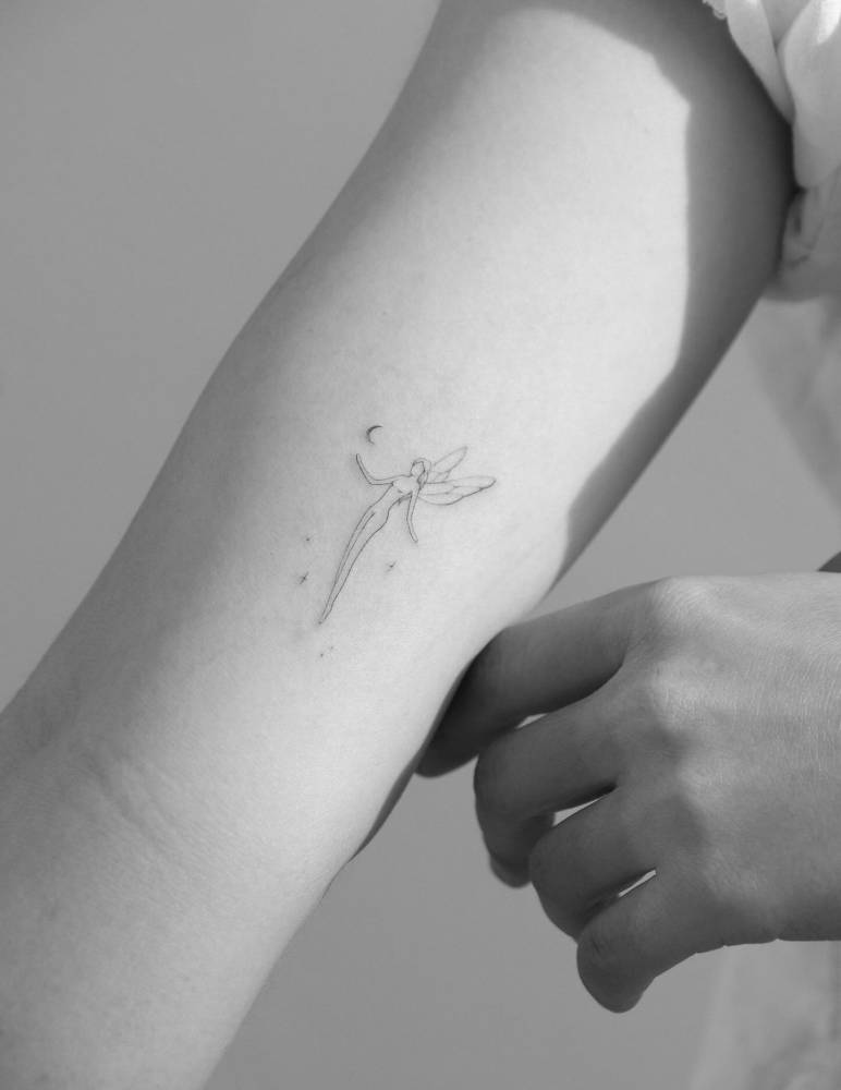 Single needle fairy tattoo located on the inner forearm.