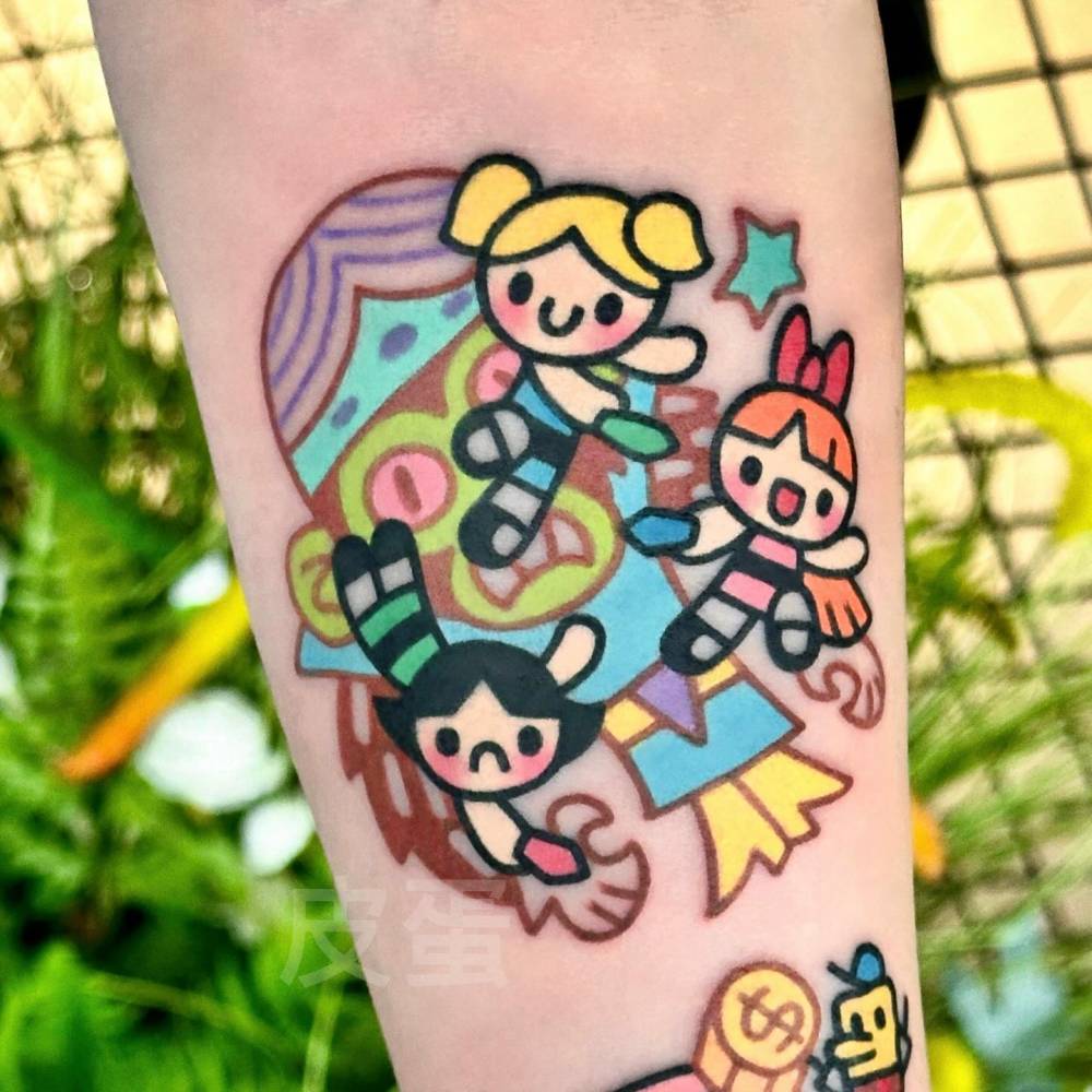Cartoon style Powerpuff Girls tattoo located on the inner forearm.