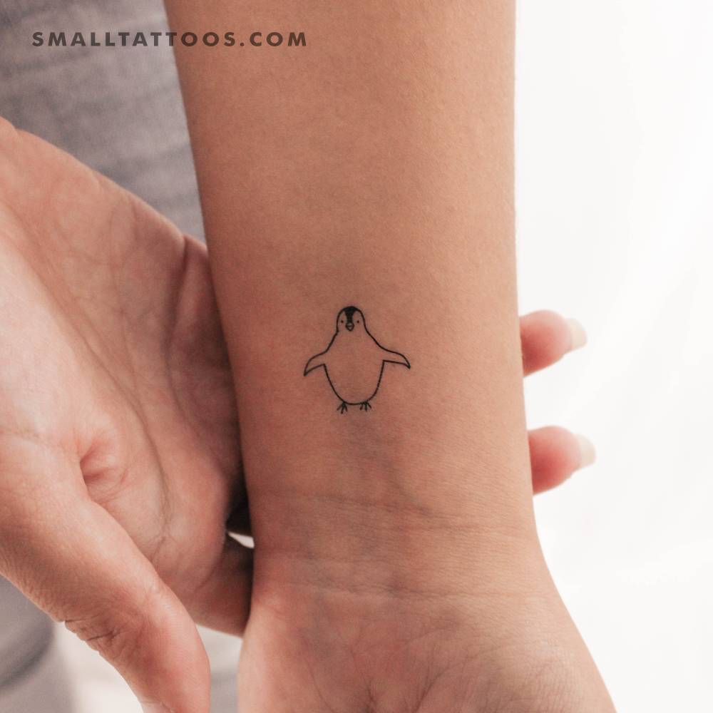 Minimalistic style penguin temporary tattoo located on the wrist.