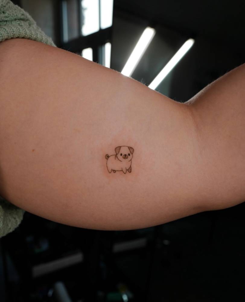 Tiny Pug tattoo in minimalistic style located on the inner arm.