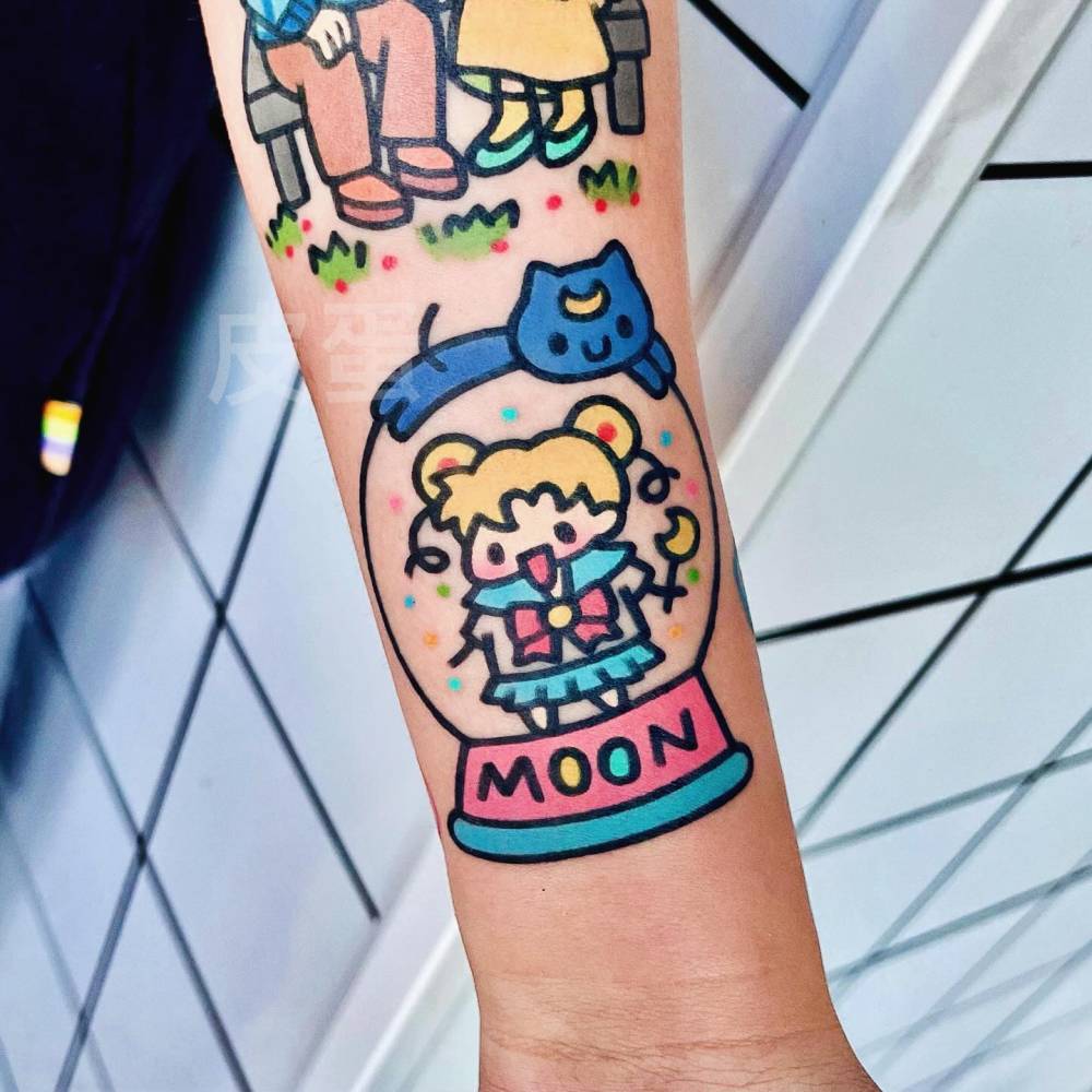 Kawaii style Sailor Moon snow globe tattoo located on the wrist.