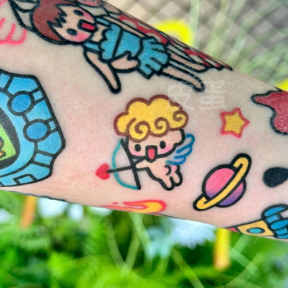 Cupid gap filler tattoo in cartoon style located on the forearm.