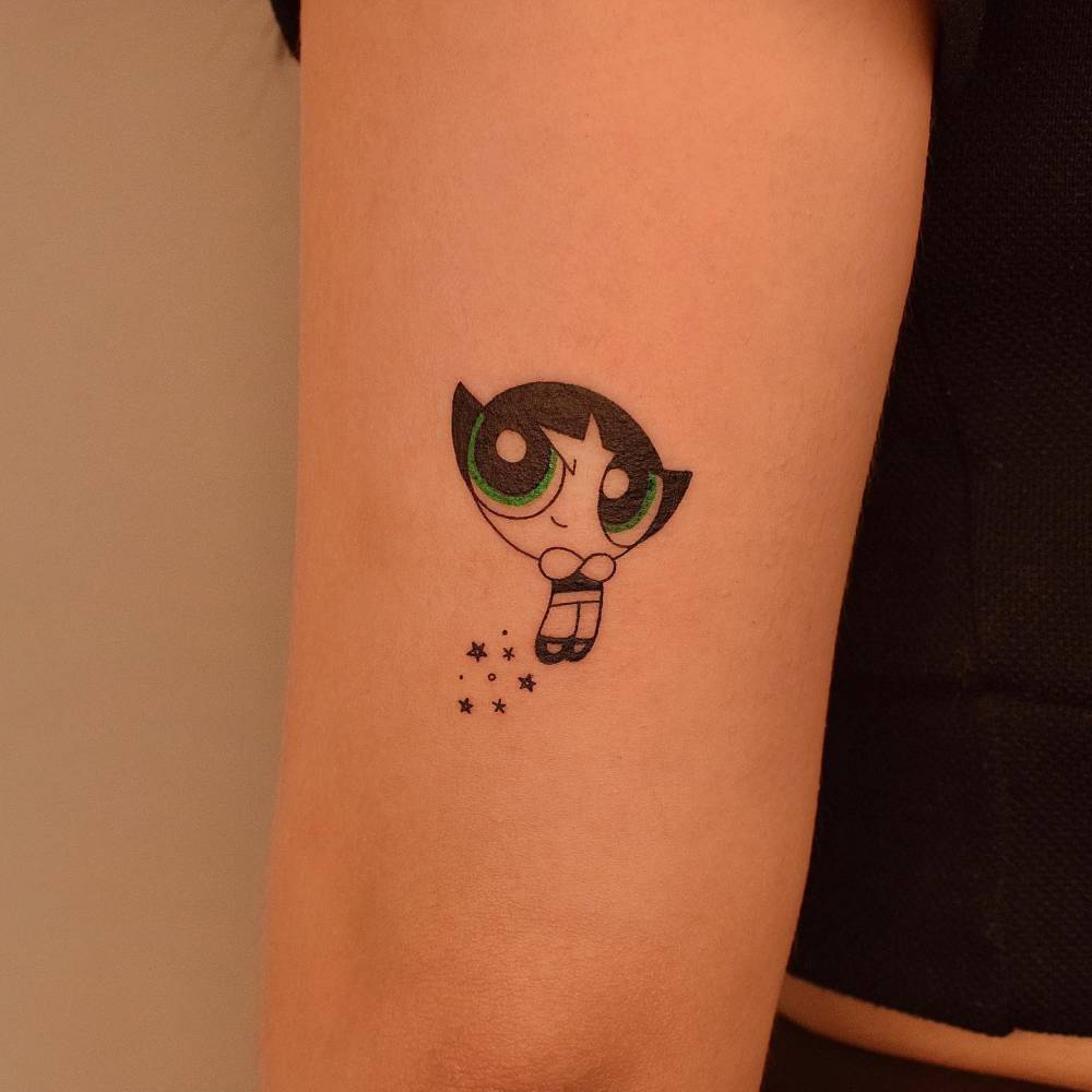 Powerpuff girl Buttercup tattooed on the tricep, cartoon style.