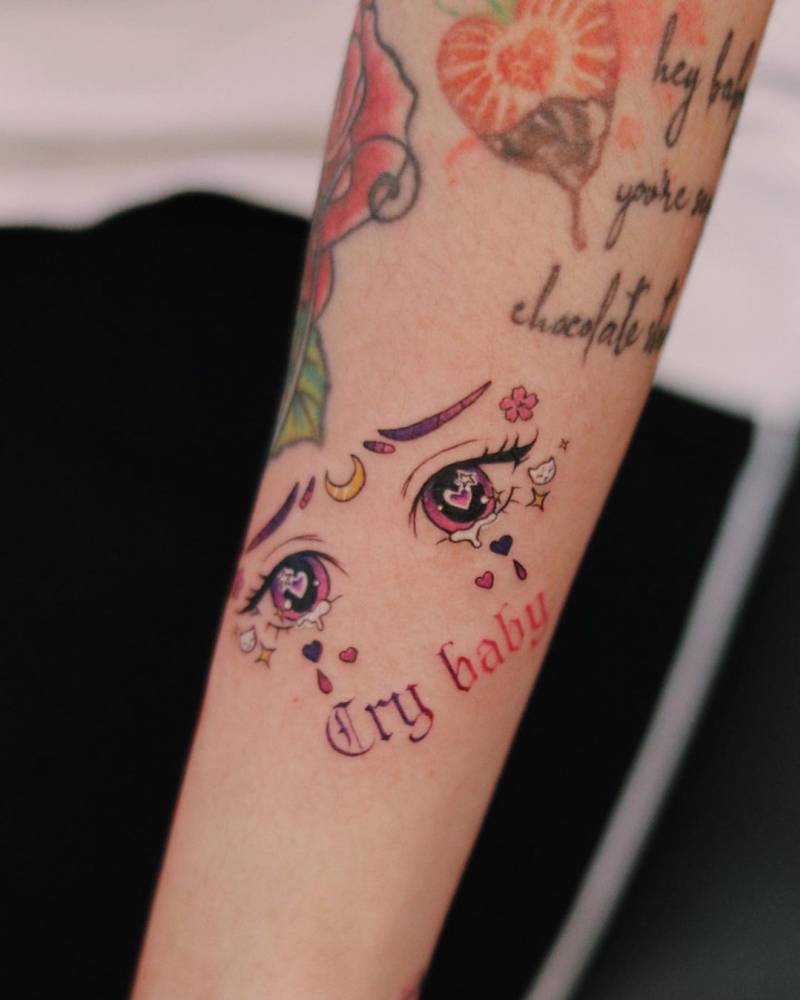 Sailor Moon crying eyes tattoo located on the forearm.