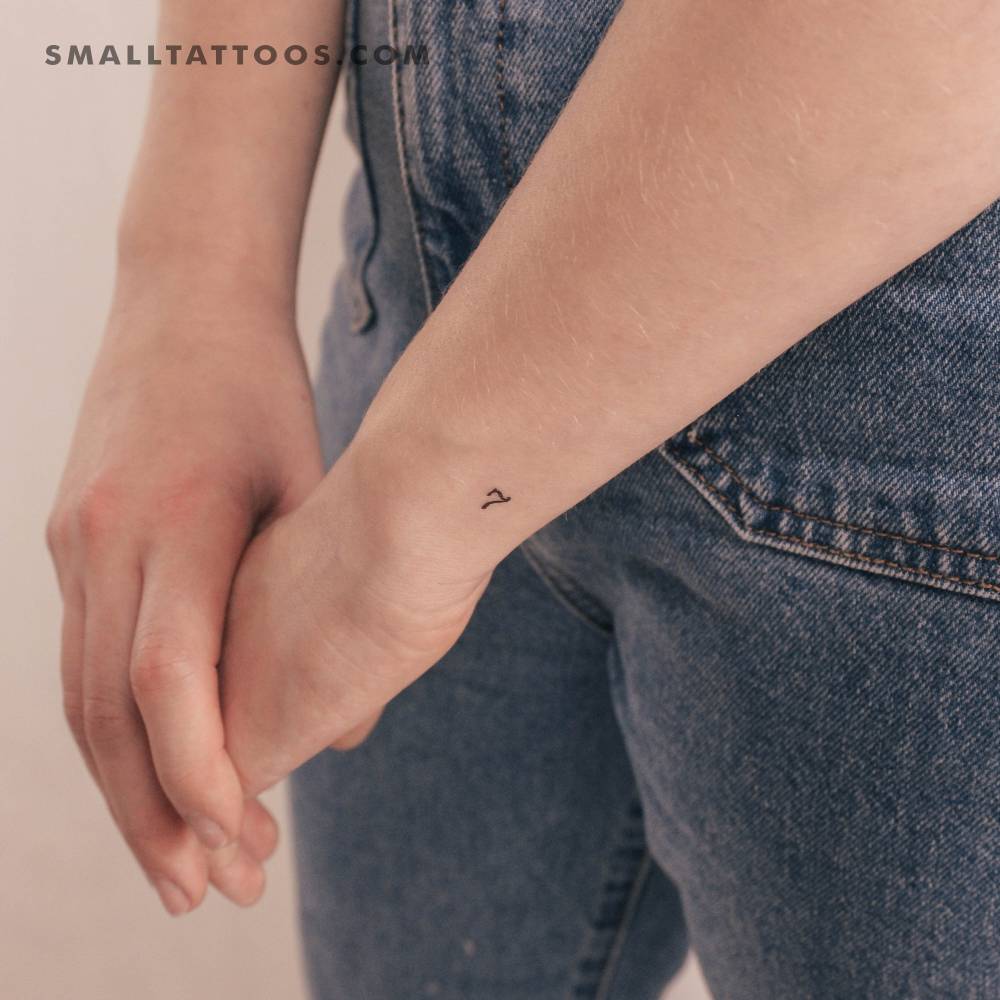 Little number 7 temporary tattoo on the wrist.