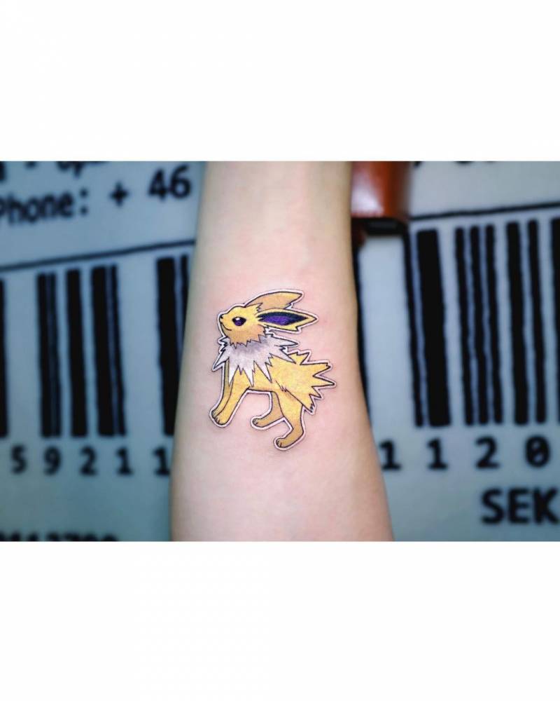 Jolteon tattoo located on the inner forearm.