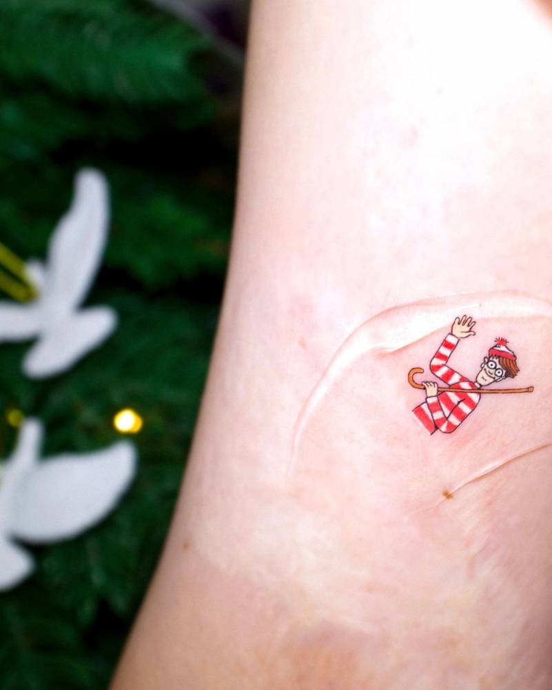 Wally tattoo located on the inner arm, cartoon style.