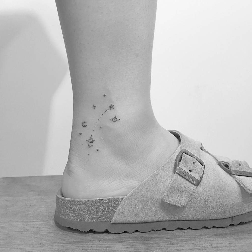 Minimalistic style galaxy tattoo done on the ankle.
