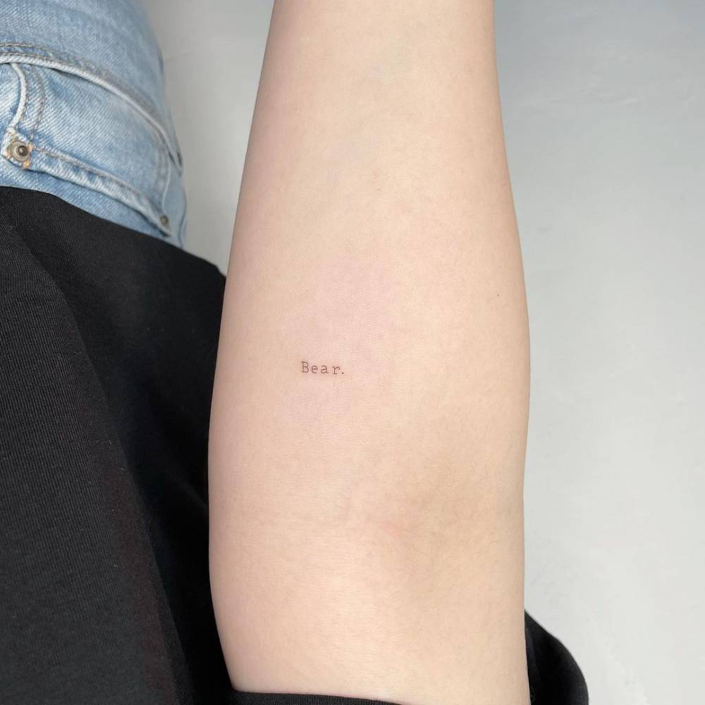 Tattoo of the word "bear" done on the inner forearm.