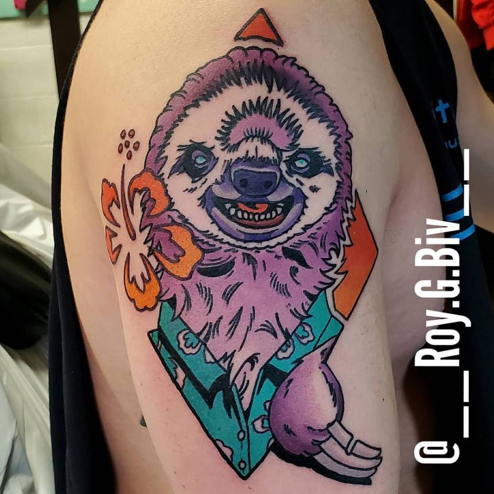 Sloth portrait tattoo located on the upper arm.