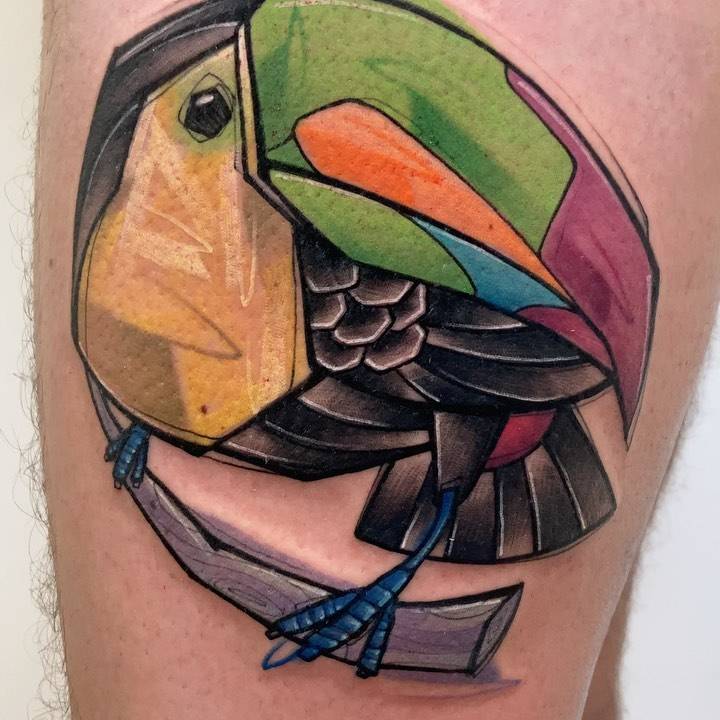 Sketch work toucan tattoo located on the thigh.