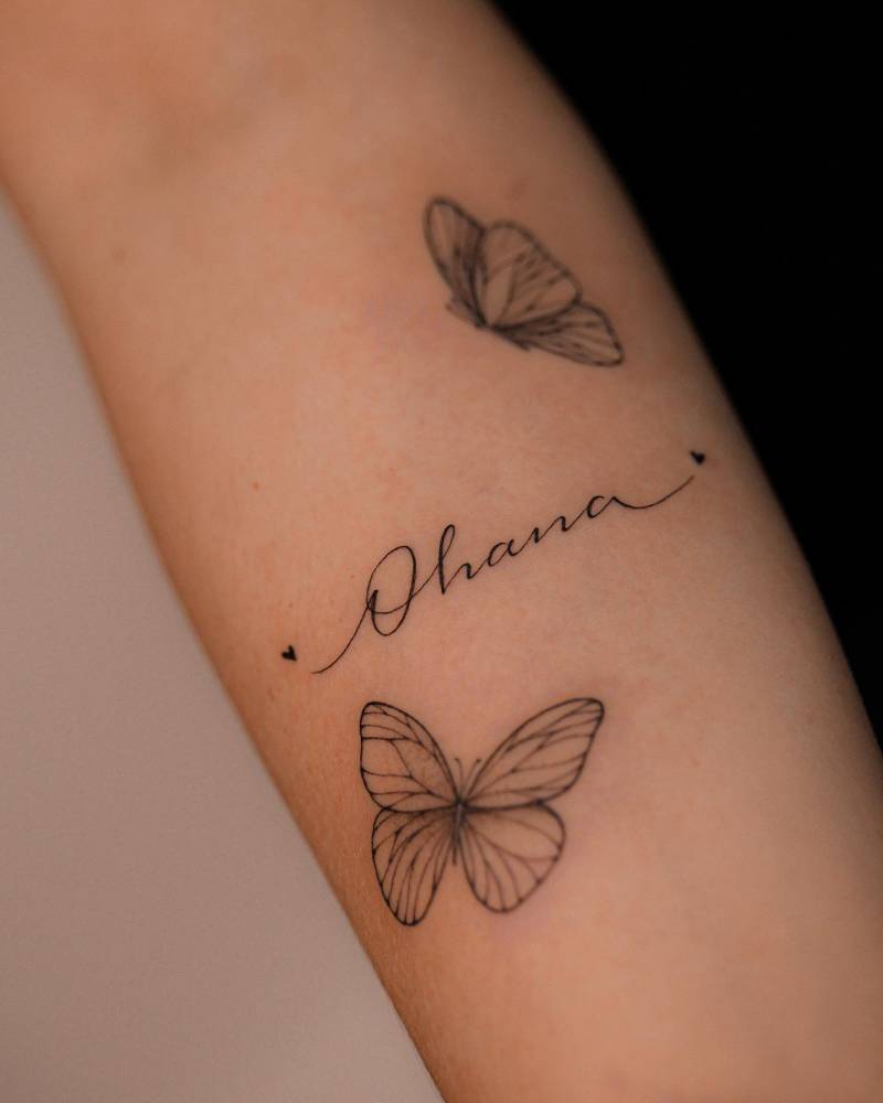 Butterfly couple and "Ohana" script tattoo located on the inner forearm.