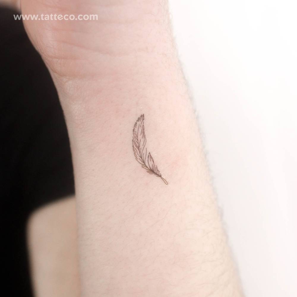 Fine line style little feather temporary tattoo located on the wrist.