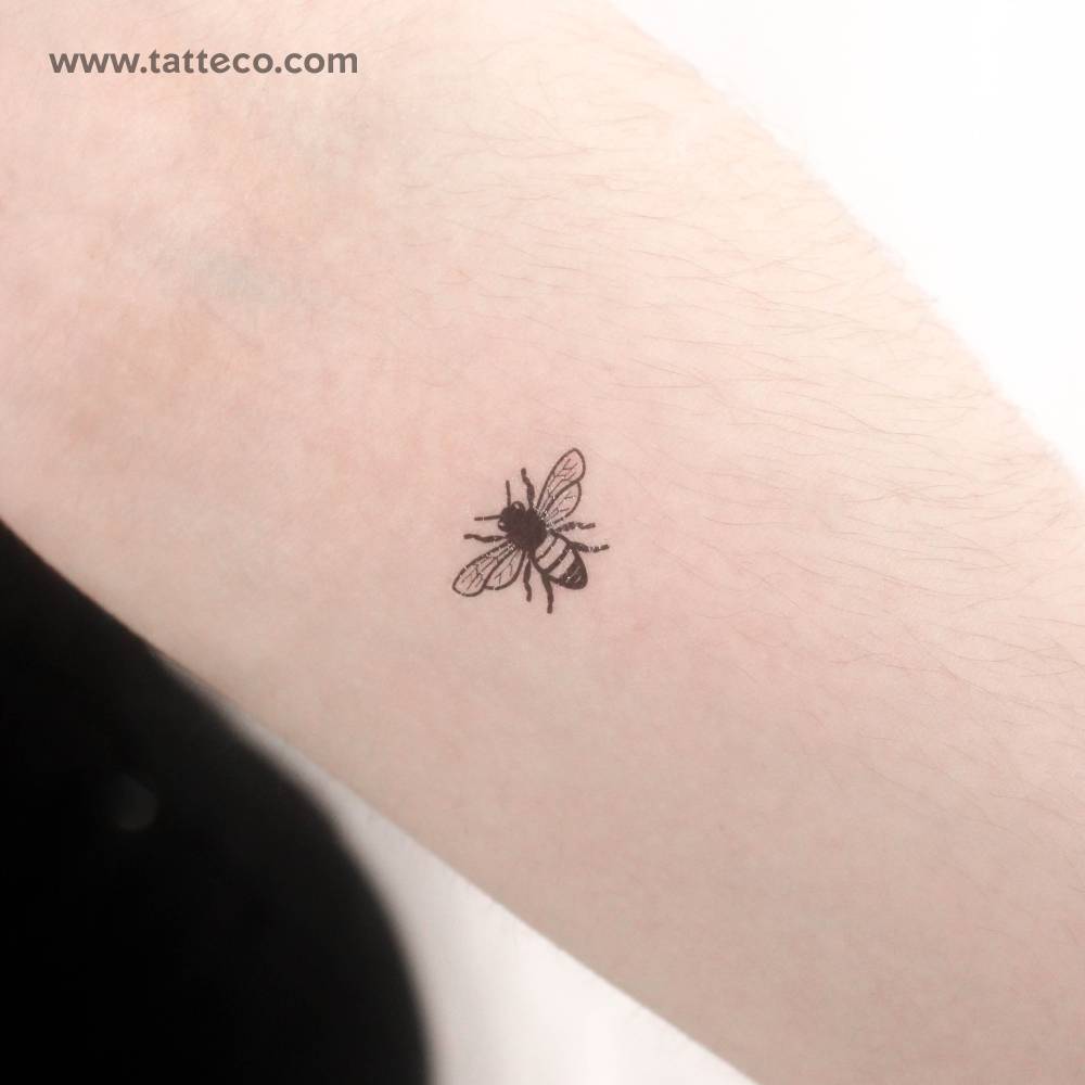 Small bee temporary tattoo located on the inner forearm.
