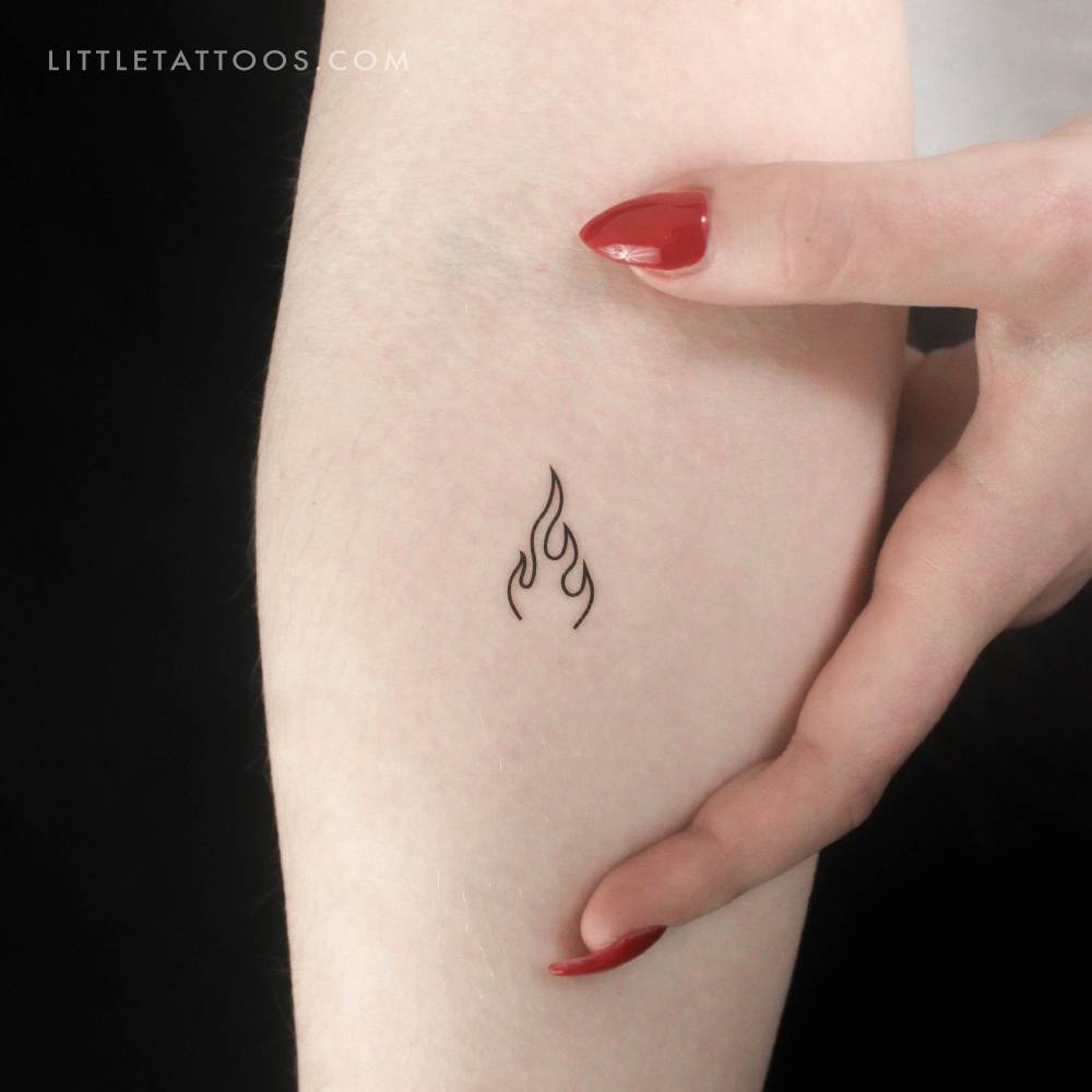 Minimalist flame temporary tattoo located on the inner forearm.