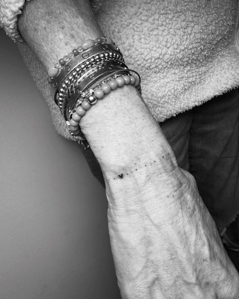 Heart wristband tattoo in minimalistic style.