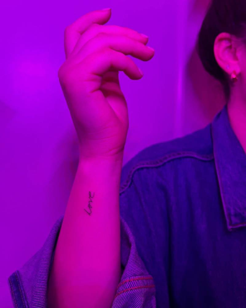 Word "love" in her mother's handwriting tattooed on the wrist.
