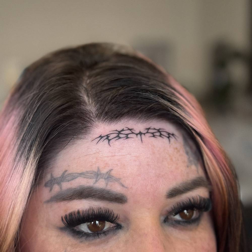 Tribal design tattooed on the forearm.