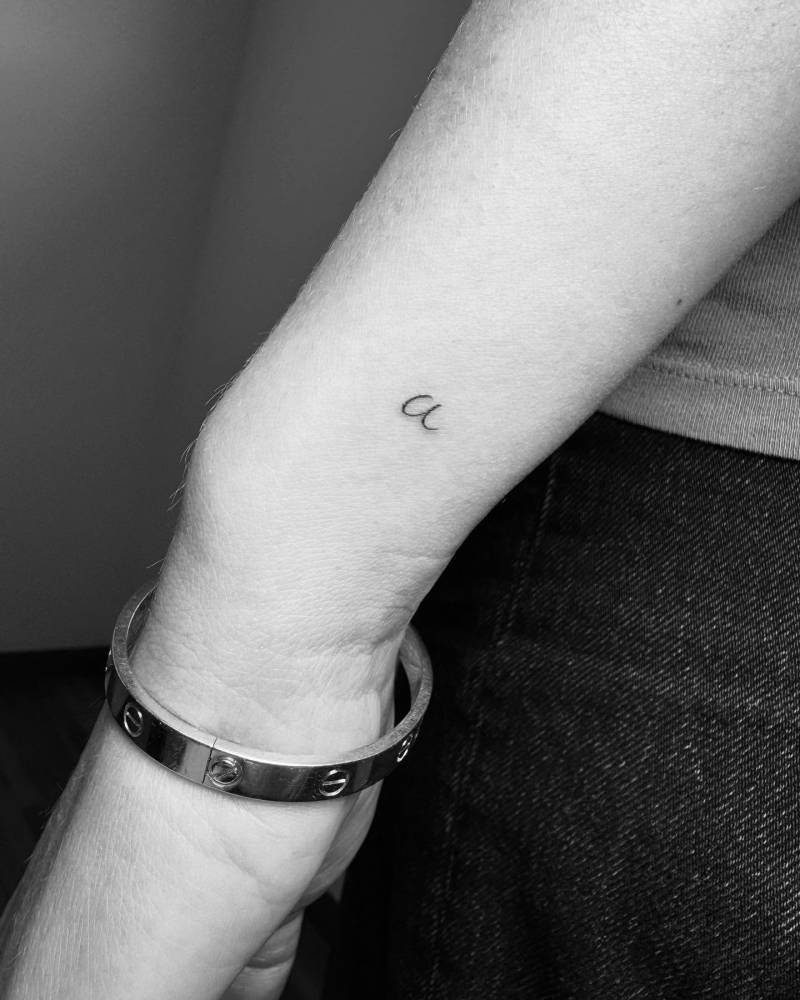 Handwritten letter "A" tattoo located on the wrist.