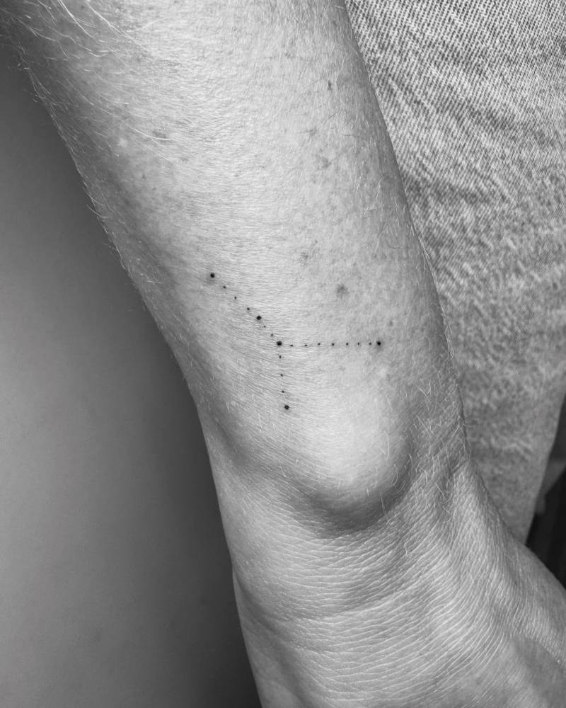 Cancer constellation tattoo in minimalistic style done on the wrist.