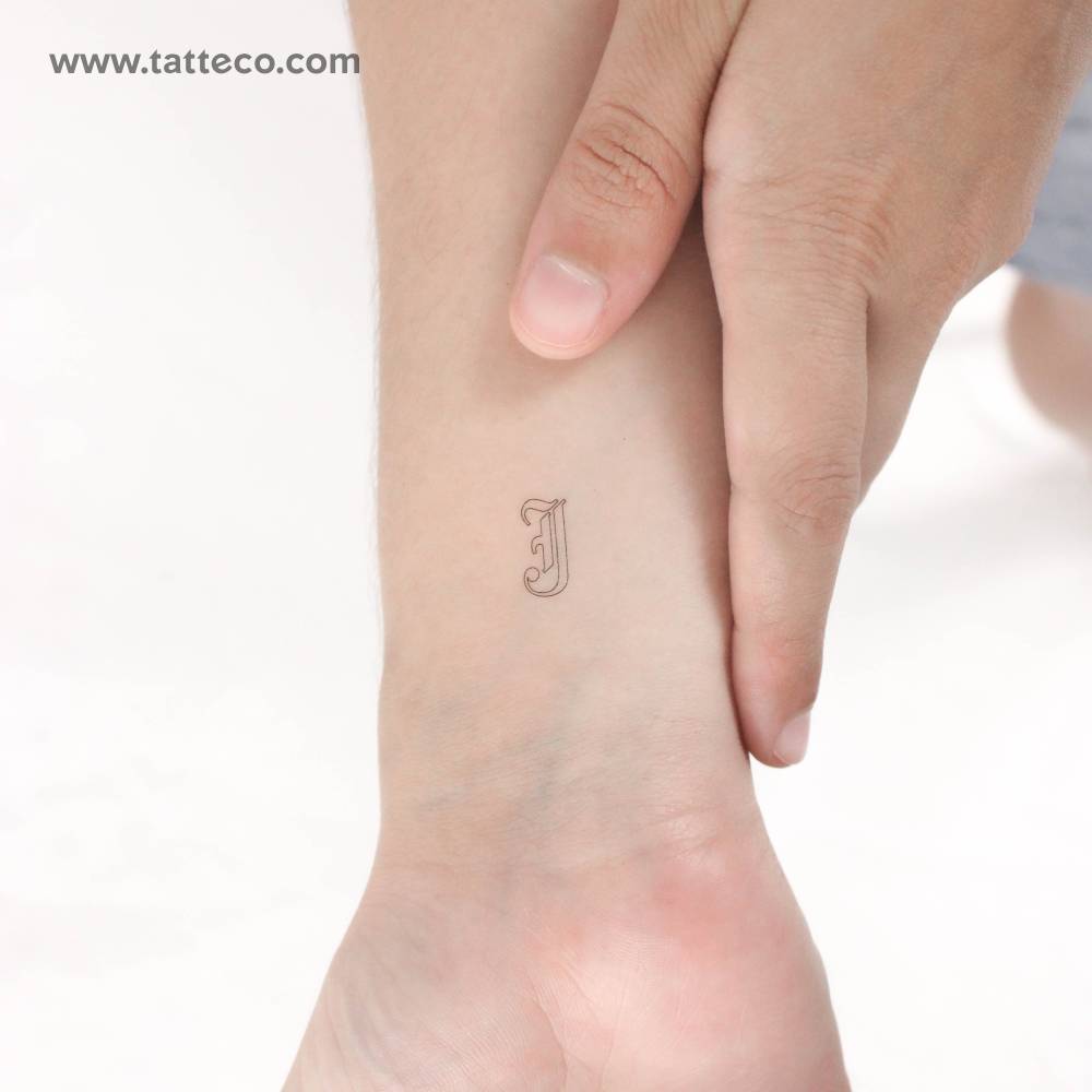 Old English "J" letter temporary tattoo placed on the wrist.