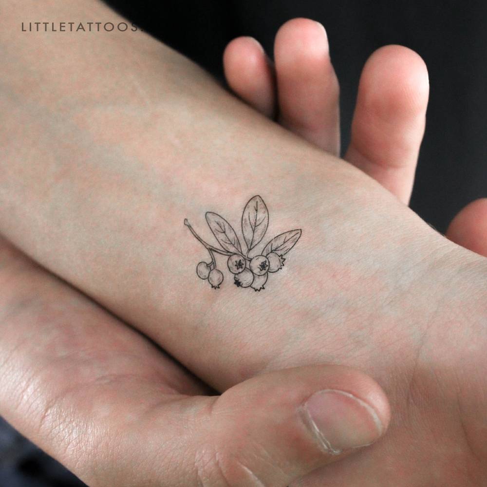 Blueberries temporary tattoo located on the wrist.