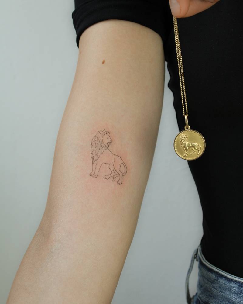Lion tattoo in fine line style done on the inner arm.
