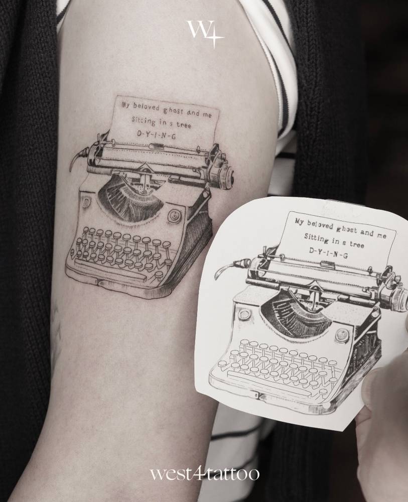 Illustrative style typewriter tattoo located on the upper arm.