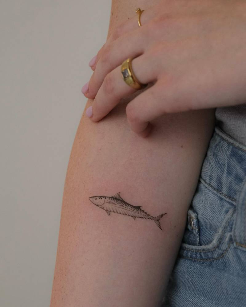 Micro-realistic style mackerel tattoo placed on the inner forearm.