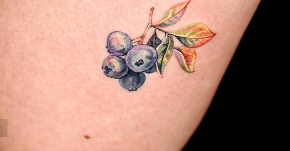 Watercolor style blueberries tattoo located on the