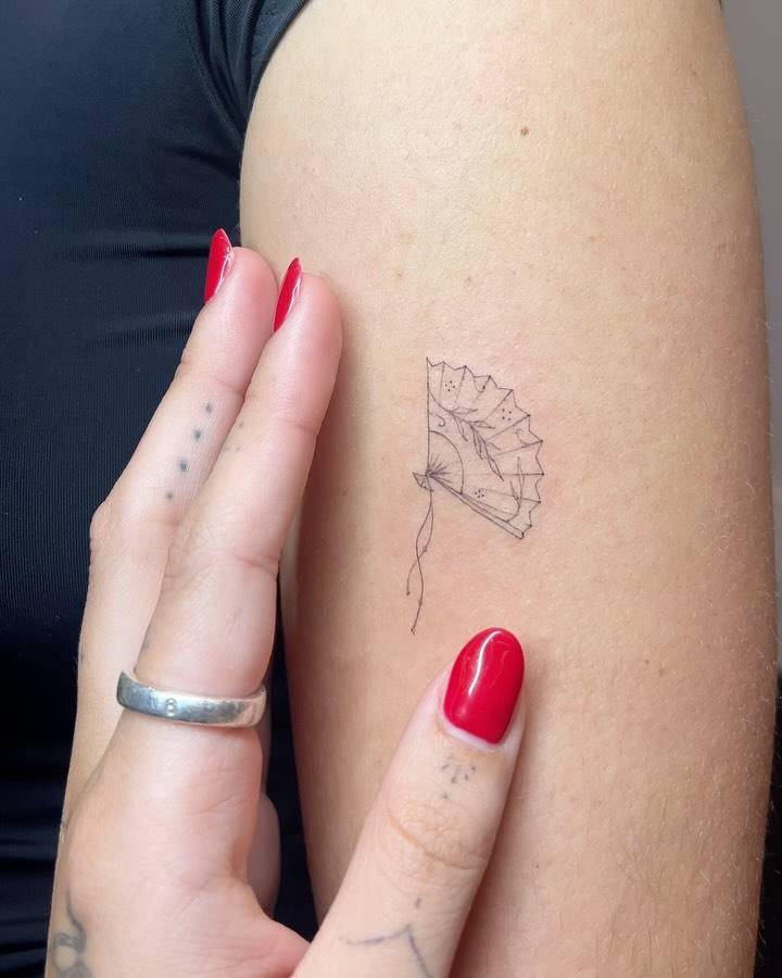 Fine line style hand fan tattoo placed on the upper arm.