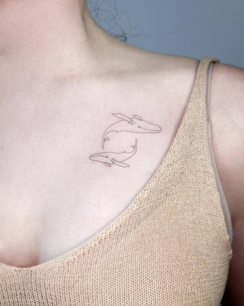 One line whales tattoo located on the chest.