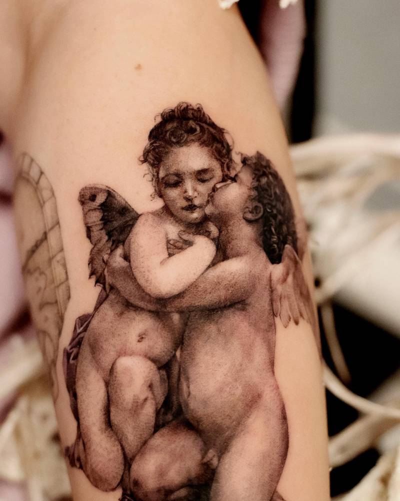 'The First Kiss' tattoo located  on the forearm, black and grey style.