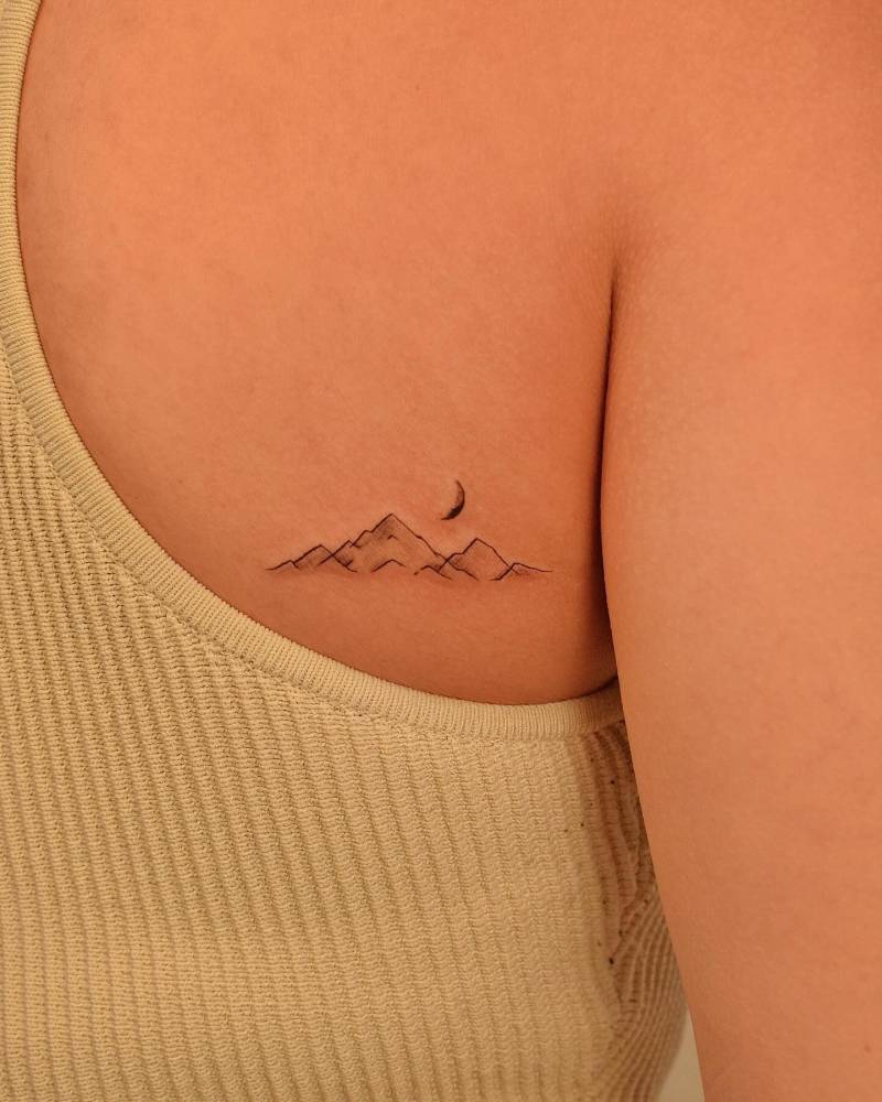Mountain tattoo located on the shoulder blade.